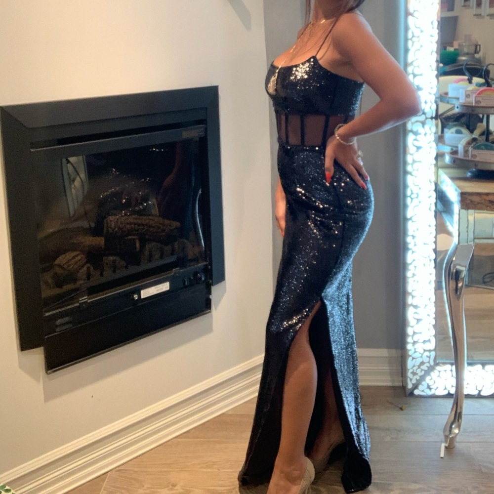 Evening dress, black sequins with corsage bones and side slit .